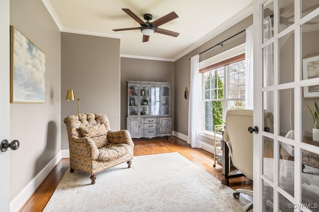 office space with ornamental molding, baseboards, and wood finished floors