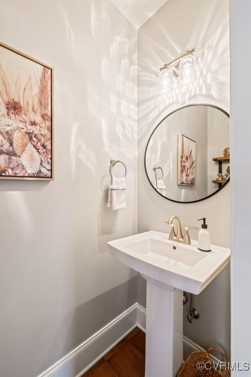 bathroom with baseboards and wood finished floors