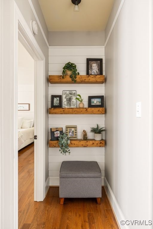 interior space featuring baseboards and wood finished floors