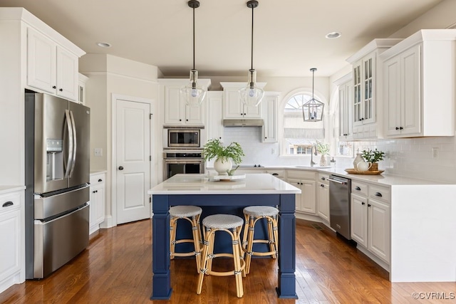 kitchen featuring appliances with stainless steel finishes, white cabinetry, and dark wood-type flooring