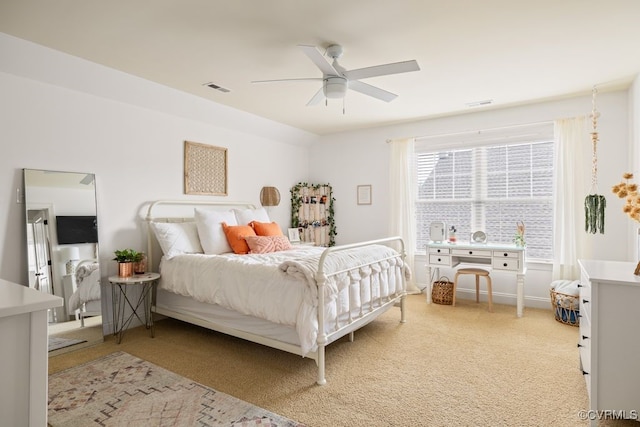 bedroom with light carpet, baseboards, visible vents, and a ceiling fan