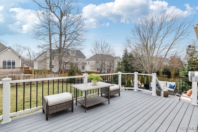 deck featuring a residential view, a lawn, and fence