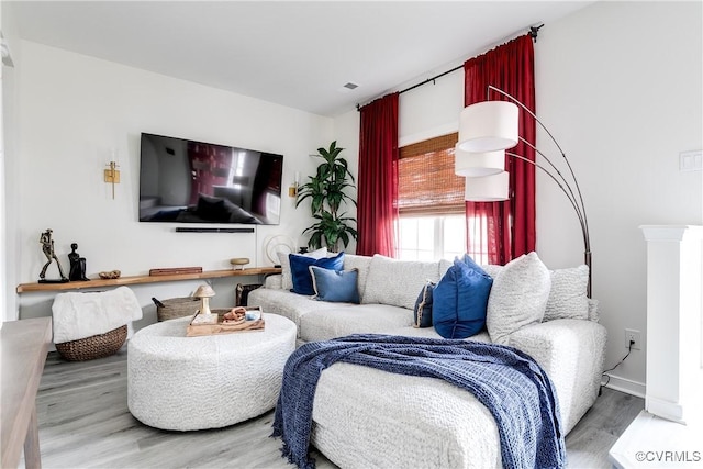 living room featuring baseboards and wood finished floors