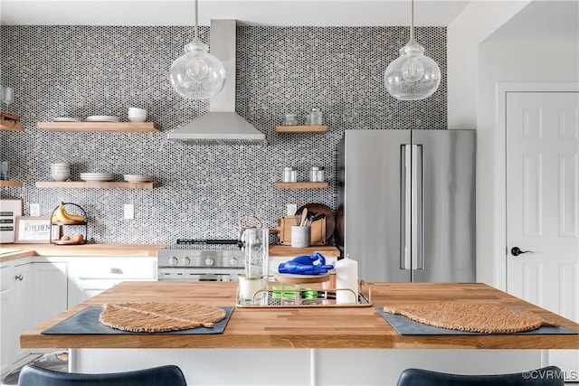 kitchen featuring open shelves, premium appliances, wood counters, and decorative backsplash