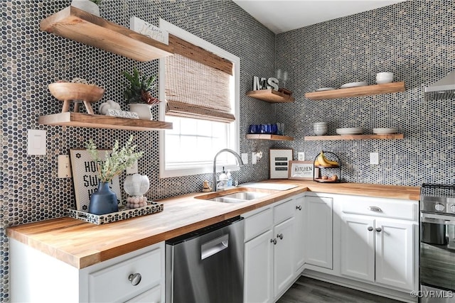 kitchen with appliances with stainless steel finishes, backsplash, wood counters, and open shelves