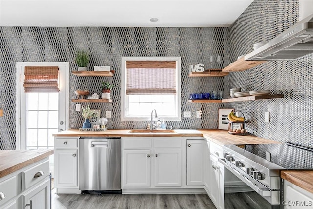 kitchen featuring open shelves, electric range oven, a sink, wood counters, and dishwasher