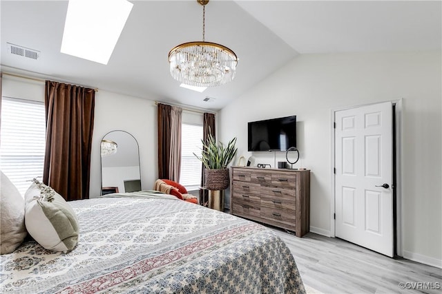 bedroom with baseboards, visible vents, lofted ceiling, an inviting chandelier, and light wood-style floors