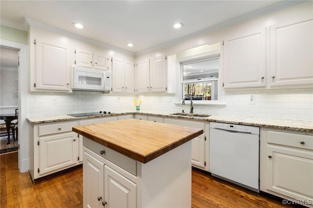 kitchen with white appliances, white cabinetry, dark wood finished floors, and a sink