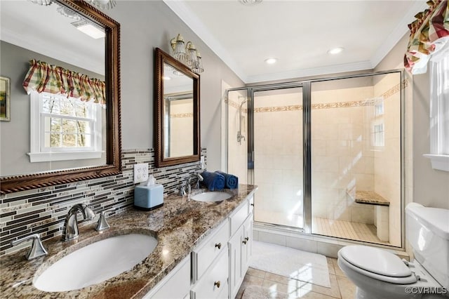 bathroom with backsplash, a sink, toilet, and a stall shower