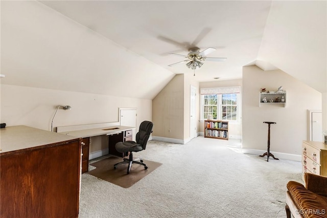 office area with a ceiling fan, lofted ceiling, light carpet, and baseboards