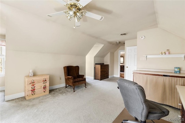 office with lofted ceiling, ceiling fan, light colored carpet, visible vents, and baseboards