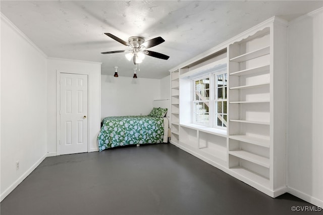 interior space with a ceiling fan, crown molding, concrete floors, and baseboards