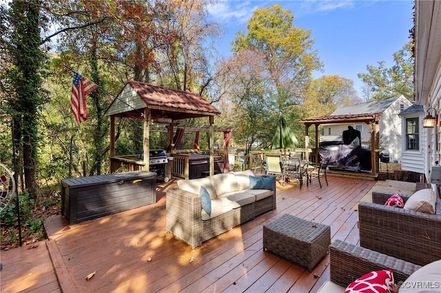 wooden terrace featuring outdoor dining area, outdoor lounge area, a hot tub, a gazebo, and area for grilling