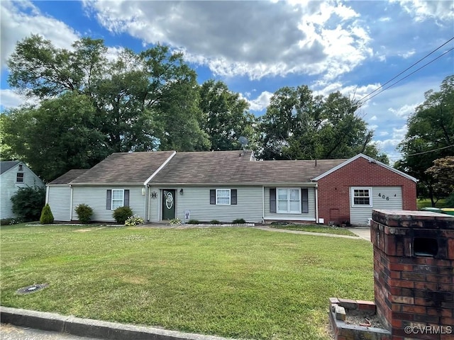 single story home featuring a garage, a front lawn, and brick siding