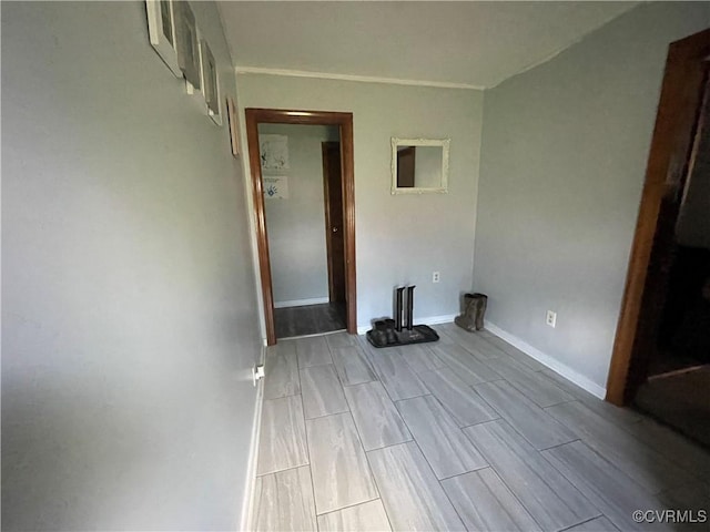 empty room with wood tiled floor and baseboards