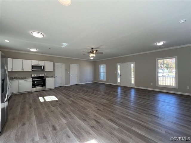 unfurnished living room featuring ornamental molding, wood finished floors, a ceiling fan, and baseboards