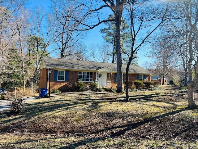 single story home featuring brick siding