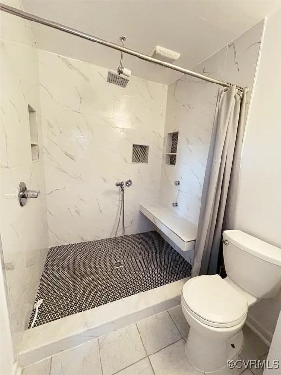 full bath with a shower stall and toilet