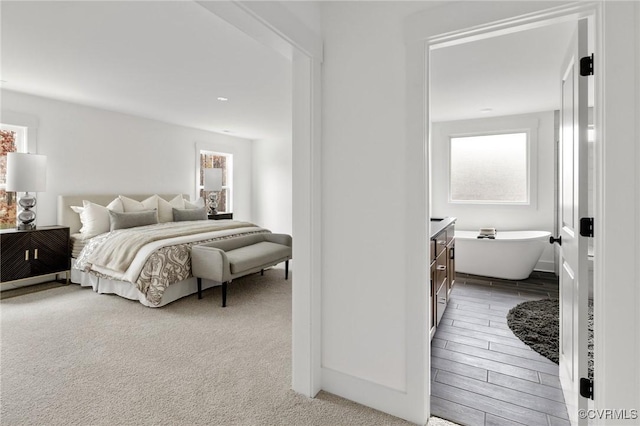 bedroom featuring baseboards and light colored carpet