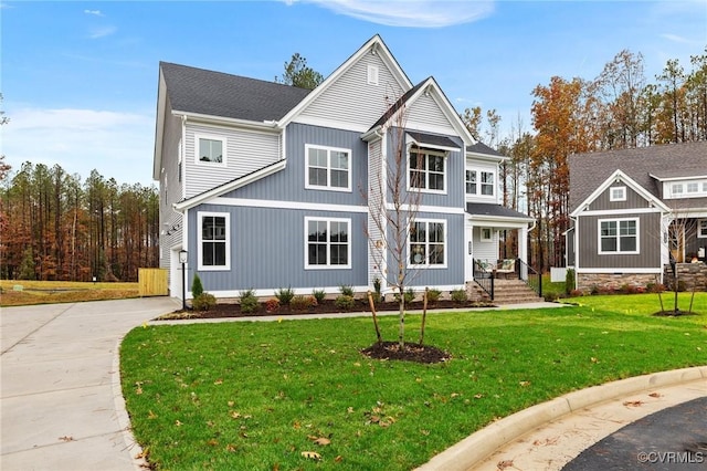 view of front facade with a front yard and concrete driveway