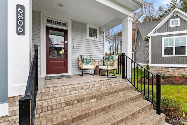 doorway to property with covered porch and board and batten siding