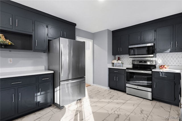 kitchen featuring marble finish floor, appliances with stainless steel finishes, backsplash, and light countertops