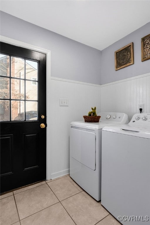 laundry area featuring laundry area, wainscoting, independent washer and dryer, and light tile patterned flooring