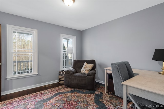 office area with a healthy amount of sunlight, baseboards, and wood finished floors