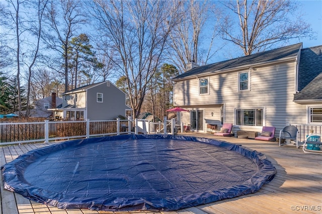 view of pool featuring a deck, fence, and a fenced in pool