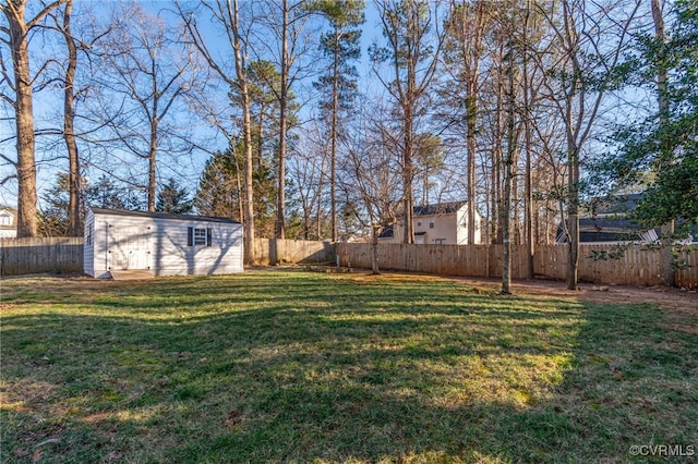 view of yard featuring an outdoor structure and a fenced backyard