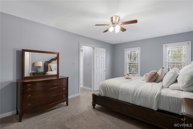 bedroom with light carpet, ceiling fan, and baseboards