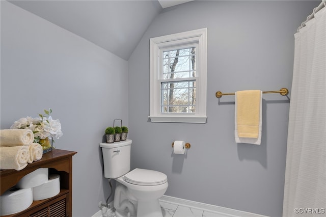 bathroom with marble finish floor, baseboards, vaulted ceiling, and toilet