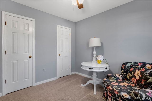 sitting room featuring carpet floors, a ceiling fan, and baseboards