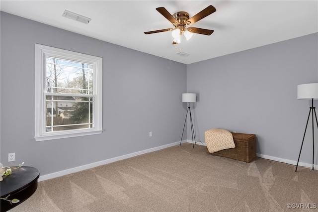 unfurnished room with carpet, visible vents, and baseboards