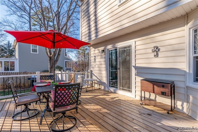 wooden terrace featuring outdoor dining area