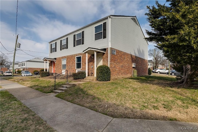 view of front of property with brick siding and a front yard