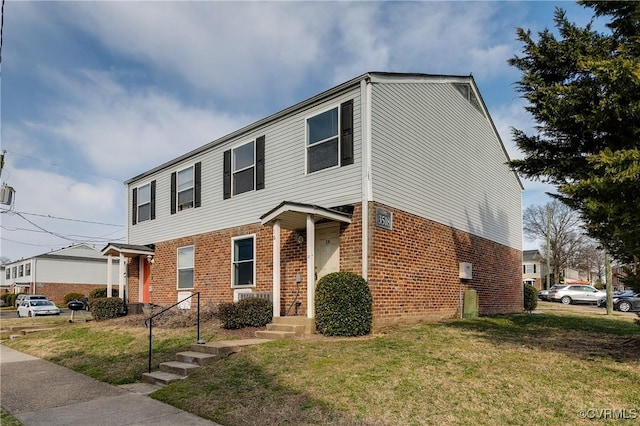 view of front of house with brick siding and a front lawn