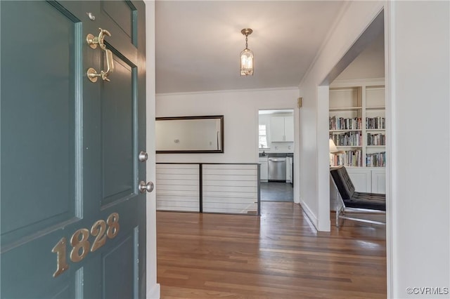 entrance foyer featuring wood finished floors and crown molding