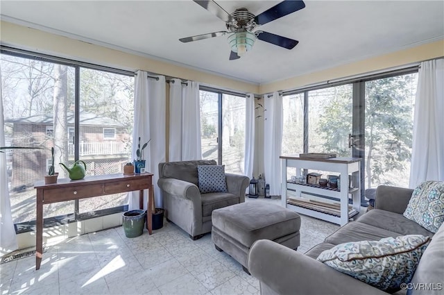 sunroom featuring a ceiling fan