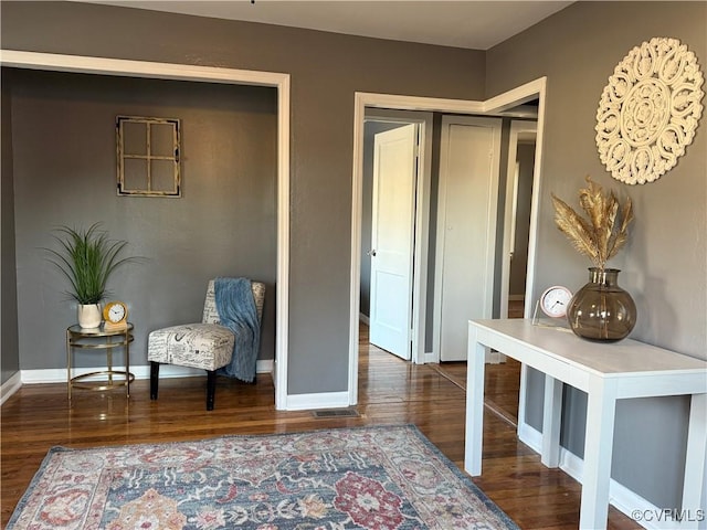 sitting room with wood finished floors and baseboards