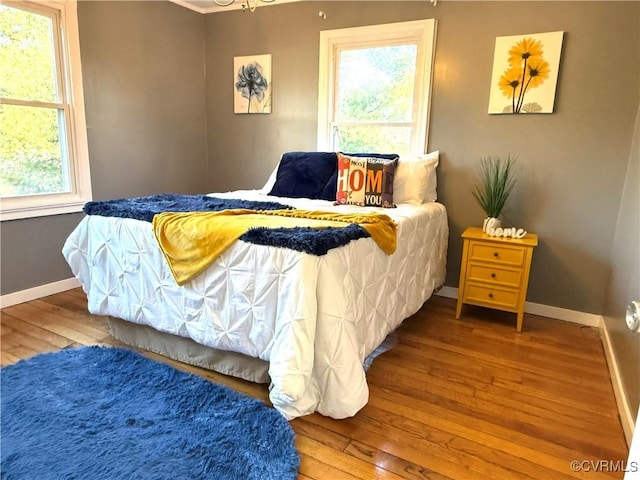 bedroom featuring wood-type flooring and baseboards