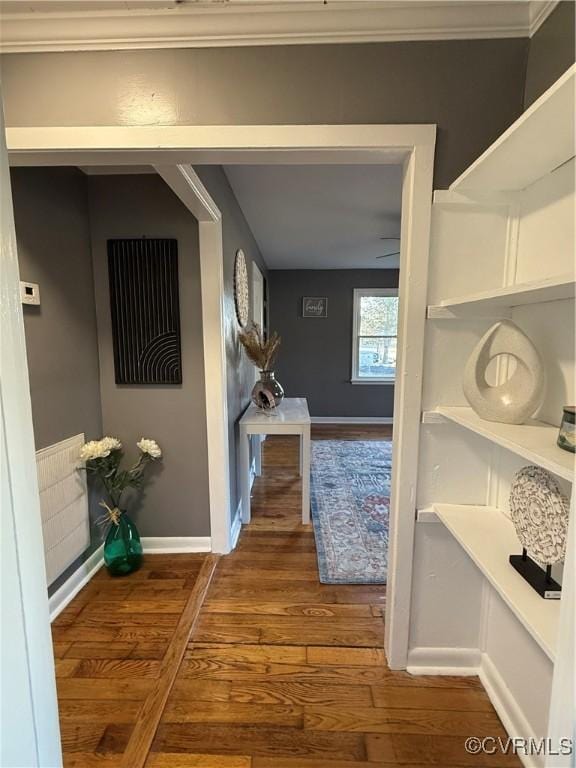 hall with baseboards and wood finished floors