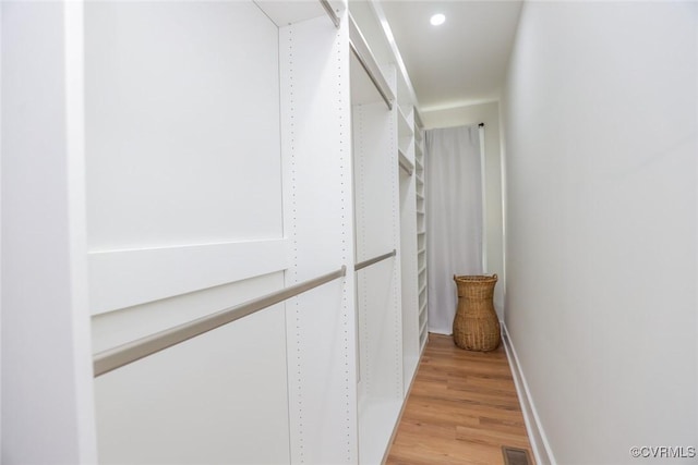 walk in closet with light wood-style flooring and visible vents