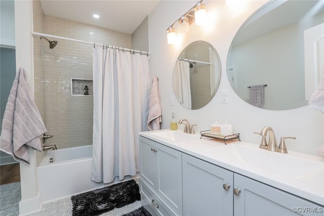 full bathroom with double vanity, a sink, shower / bath combo with shower curtain, and recessed lighting