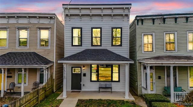 view of front of home featuring covered porch and a patio