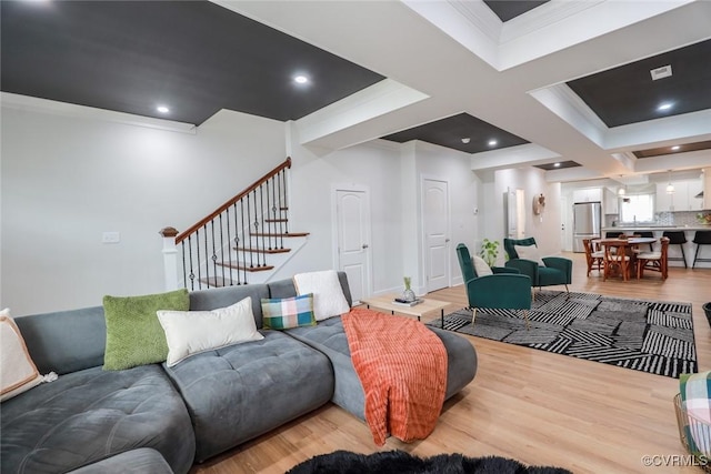 living room featuring ornamental molding, recessed lighting, stairway, and wood finished floors