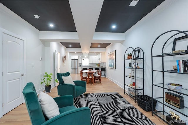 sitting room with recessed lighting, light wood-style flooring, baseboards, and ornamental molding