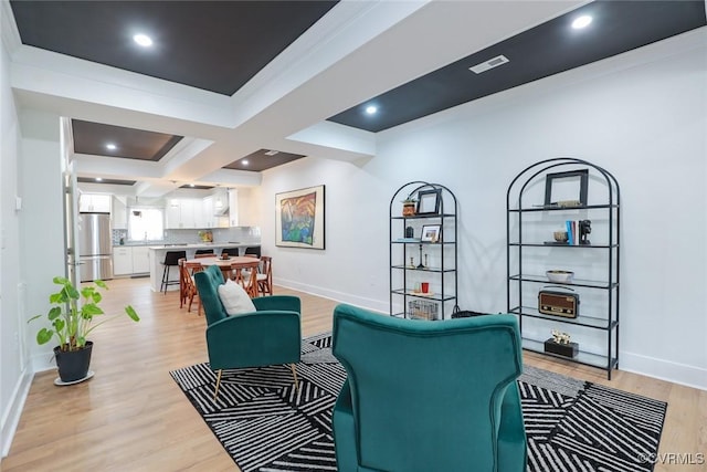 living area with light wood-type flooring, visible vents, baseboards, and recessed lighting