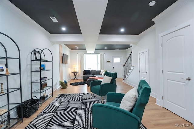 living room featuring light wood finished floors, visible vents, stairway, ornamental molding, and baseboards