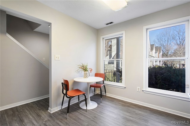 dining space with visible vents, baseboards, and wood finished floors